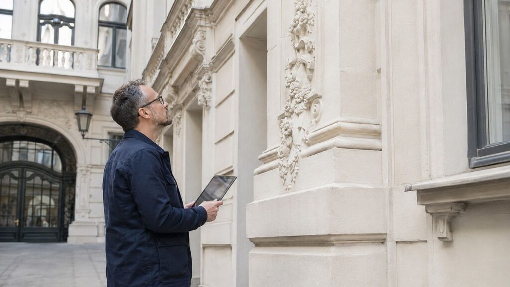 Gutachter erfasst bei der Prüfung eines Wiener Gebäudes Feststellungen digital am Tablet